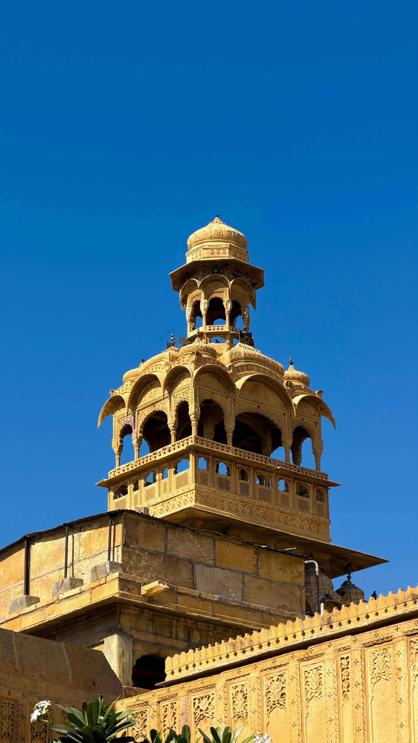 Stunning view of traditional architecture in Jaisalmer, Rajasthan against a clear blue sky.