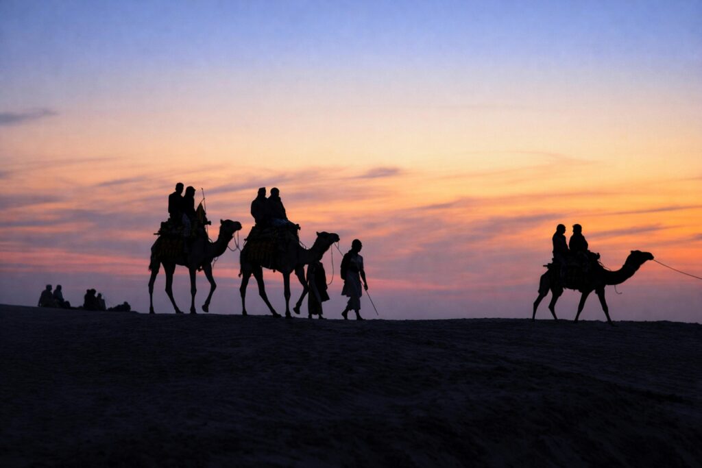 A scenic camel ride at sunset in the deserts of Jaisalmer, Rajasthan, offering a beautiful silhouette.